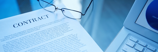A contract paper and a reading glasses